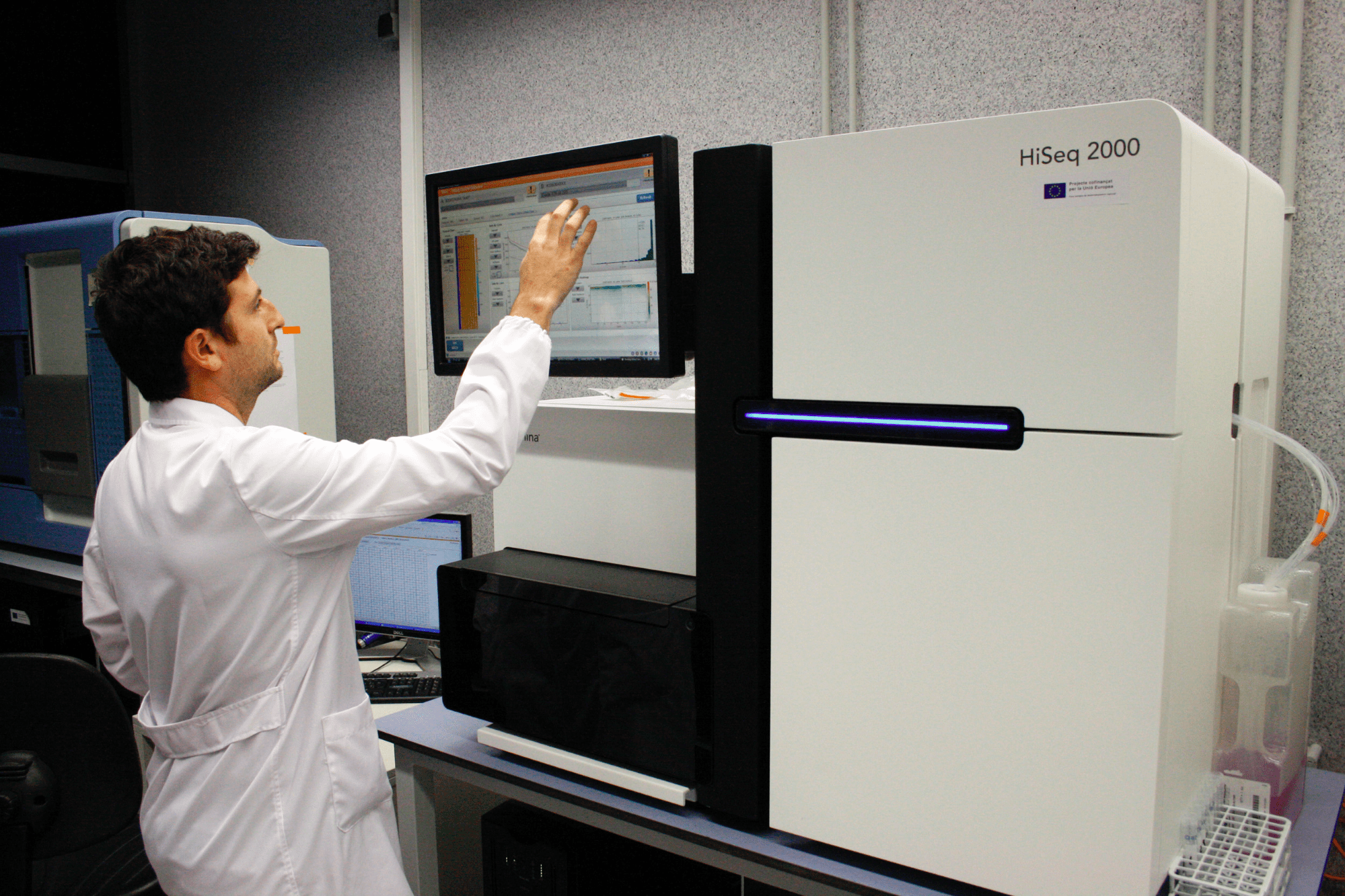 A reseracher operates an automated HiSeq sequencing machine. Flickr Creative Commons image. 